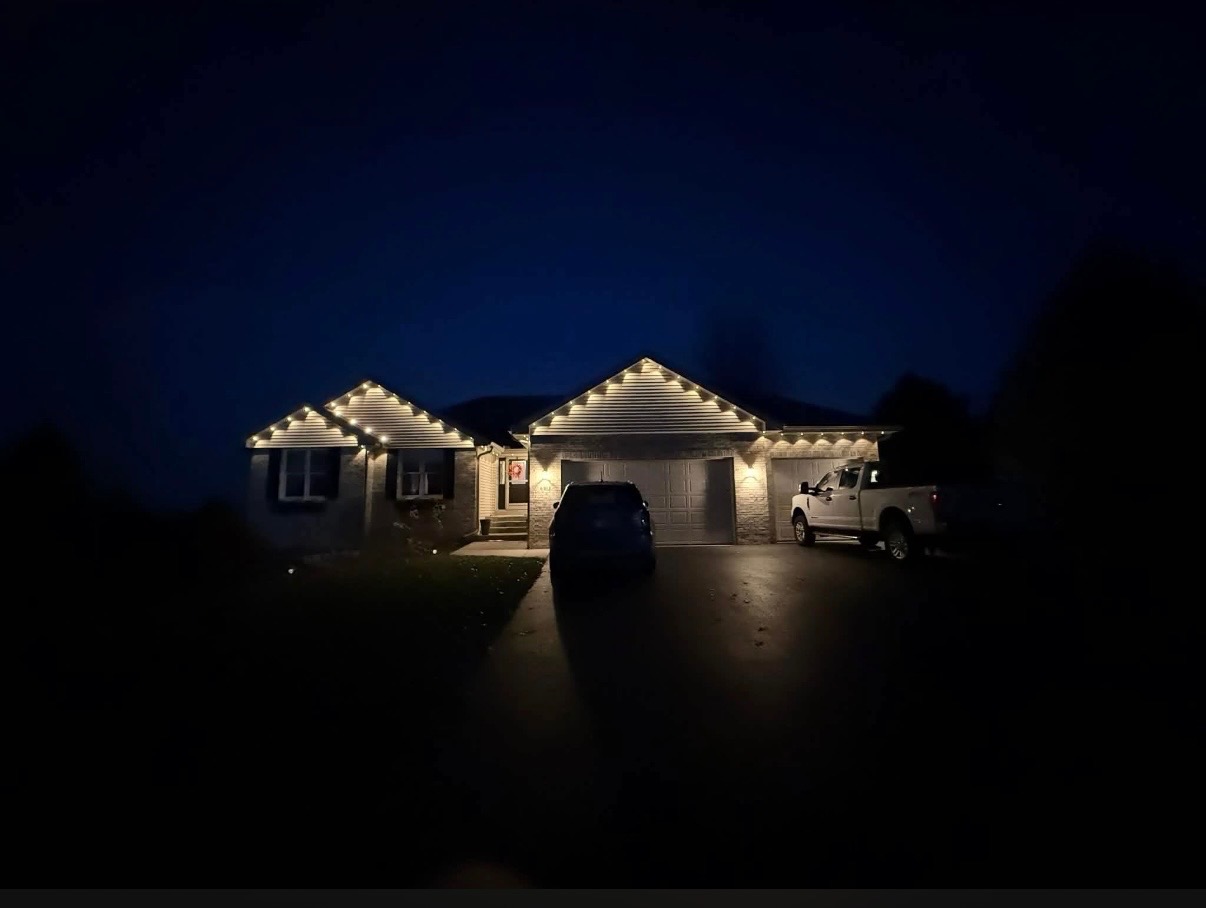 Custom Christmas Light Display Home decorated with colorful custom Christmas lights at night