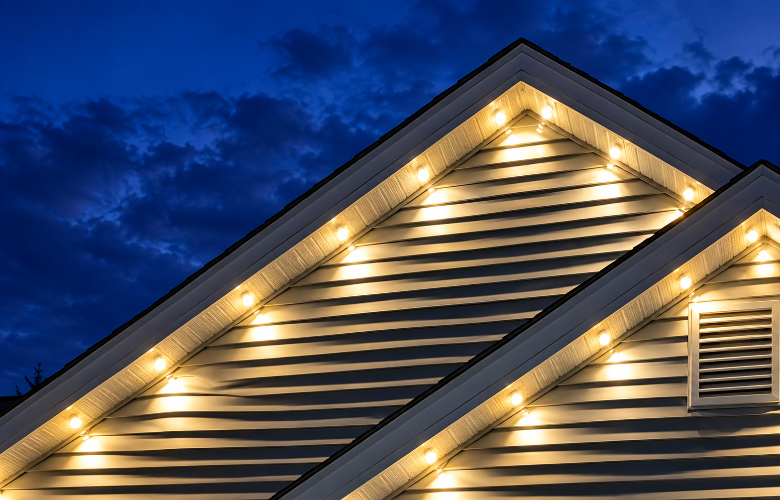 c2e7dda3-4f67-4137-9249-c5c1c94e4eca Warm white Christmas lights along a home's roof gables